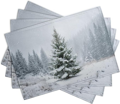Set of 4 winter placemats, overlapping view, frosty pine tree and snow landscape.