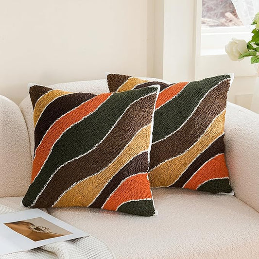Tufted throw pillow cover with multicolor striped design, dark green and orange accents