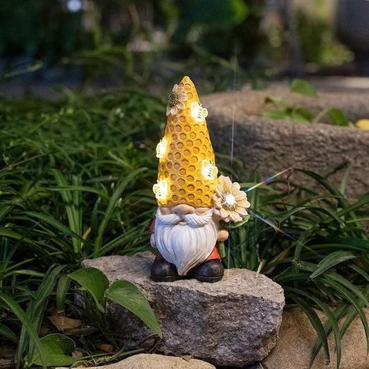 Solar garden gnome statue with glowing honeycomb-yellow head, white beard, and flower