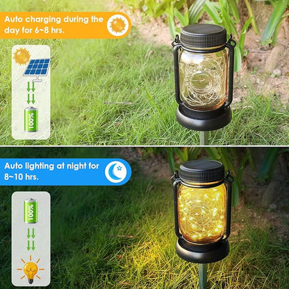 Solar mason jar hanging lantern on ground with warm yellow light from clear glass