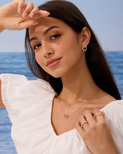 Gold open-circle pendant necklace on a model, with a delicate fine chain