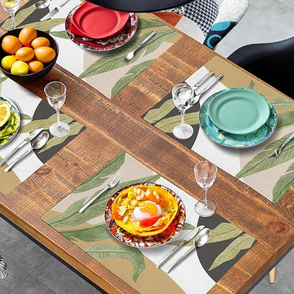 Tropical leaf placemat on wood table, green banana and palm prints with tan blocks