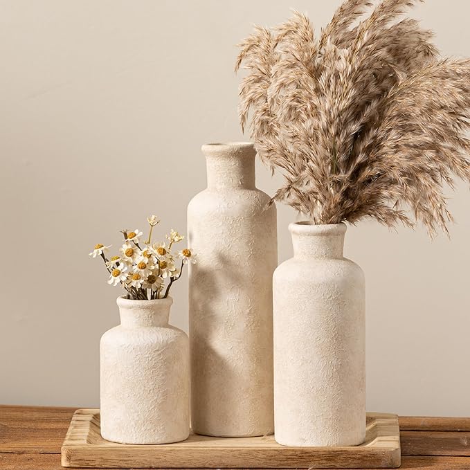Set of 3 whitewashed ceramic vases with textured speckled surface, stacked on base
