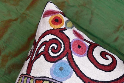 White pillow cover side view with multicolor swirl and dot pattern