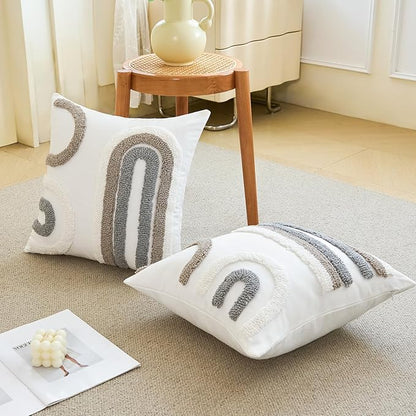 White tufted pillow covers with gray arched patterns, styled on couch