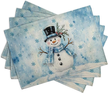 Blue rectangular winter placemats set of 4 featuring snowman and scattered snowflakes.