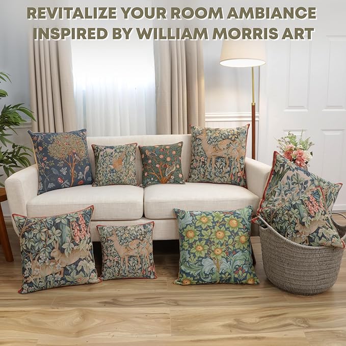 Square pillow cover on sofa, dark blue botanical tapestry with orange blossoms and green foliage