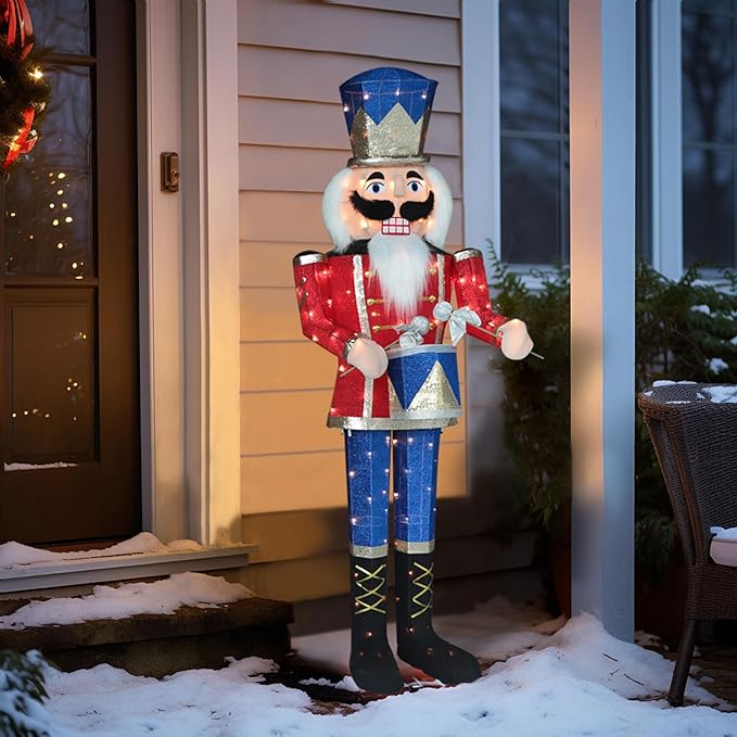 Pre-lit nutcracker soldier decoration with blue hat, red coat, and warm white lights