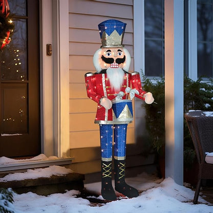 Pre-lit nutcracker soldier decoration with blue hat, red coat, and warm white lights