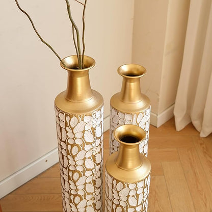 Three matching antique white and gold twig-pattern metal floor vases with open tops