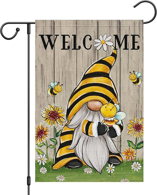 Burlap-style yard flag with Welcome text, smiling gnome holding honey, bees and daisies