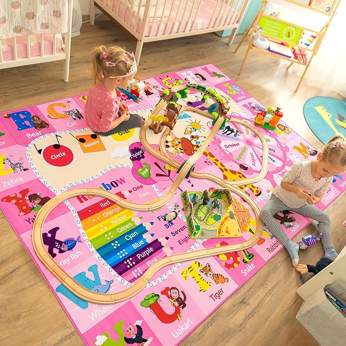 Pink alphabet and animal kids play rug with large curved paths and letter labels.