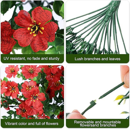 Close-up of red faux blossoms with green leaves and long trailing stems