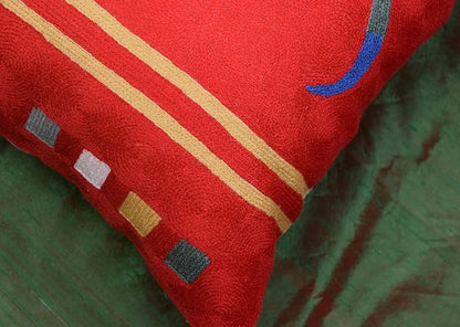 Red abstract pillow cover close-up of striped bands and small square motifs