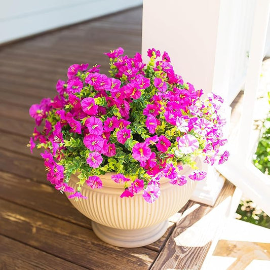 Fuchsia and light pink faux morning glory flowers with green foliage, planter