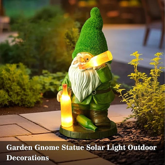 Garden gnome statue with glowing solar lantern, green hat and white beard on patio