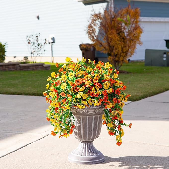 Artificial hanging flower bundle with orange and yellow blooms on outdoor pedestal