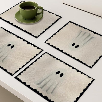 Four ghost placemats, off-white with scalloped black border, rectangular polyester