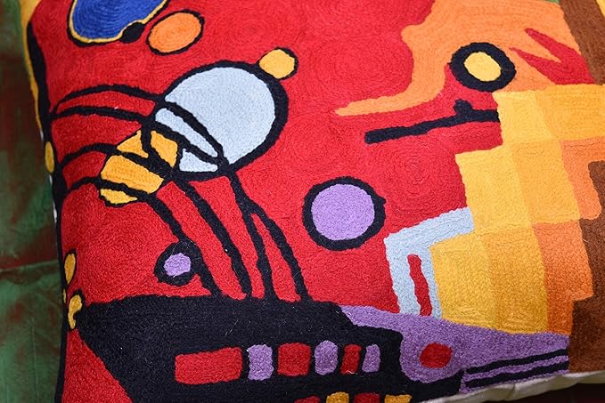 Close-up of red abstract embroidered pillow cover with navy outlines and purple dots