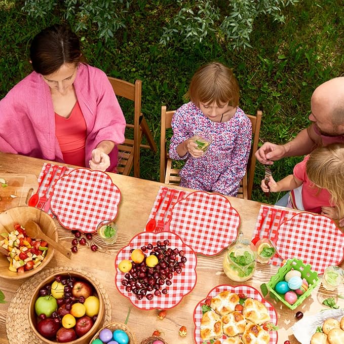Red and white gingham picnic tableware set with multiple plates and cups on the table