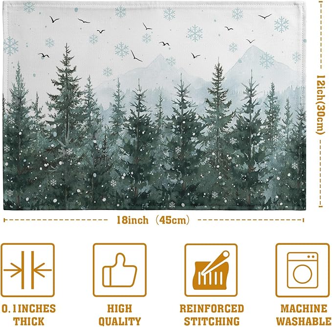 Set of 4 placemats with snowy pine trees, snowflakes, and small flying birds