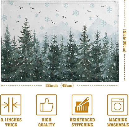 Set of 4 placemats with snowy pine trees, snowflakes, and small flying birds