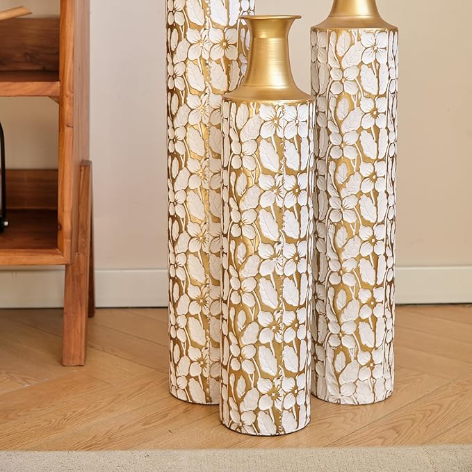 Three antique white and gold twig-pattern metal floor vases, varied heights