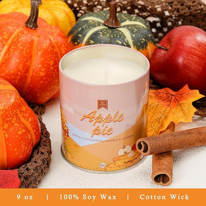 Pink soy candle jar labeled with apple pie motif; cinnamon sticks and fruit nearby