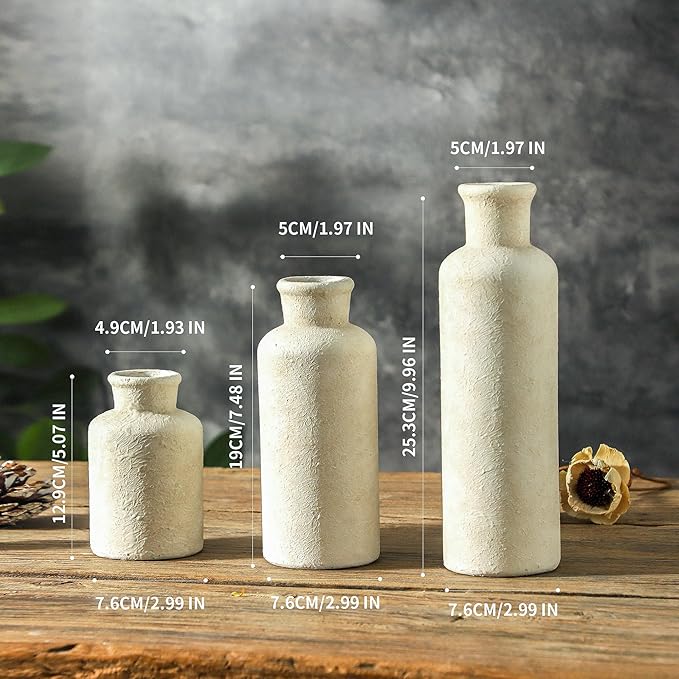 Three whitewashed ceramic vases, different heights, textured speckled surface