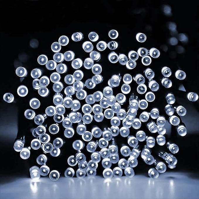 Close-up Christmas LED string lights with cool white mini bulbs on green wire