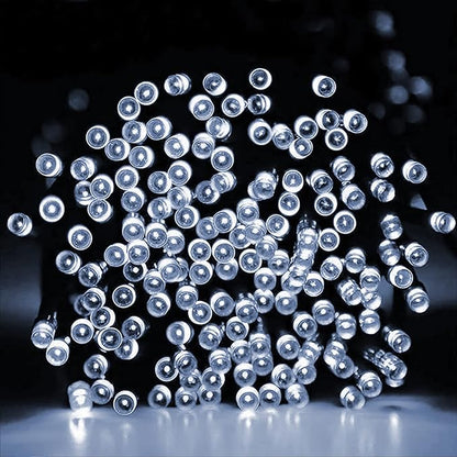 Close-up Christmas LED string lights with cool white mini bulbs on green wire