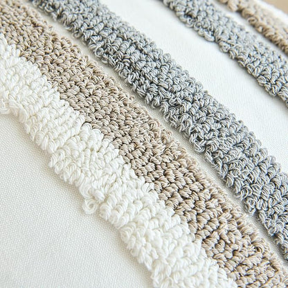 Close-up textured crochet pillow cover stripes in white, beige, and gray