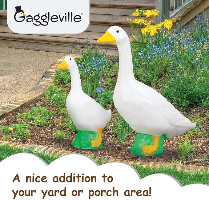 Large and small white goose statues displayed together