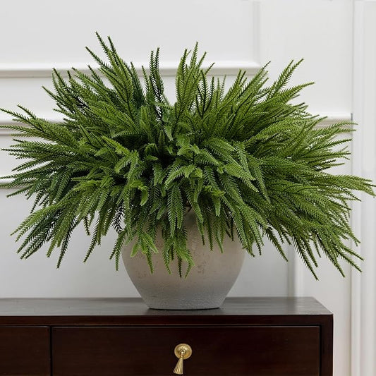 Artificial Norfolk pine branches arranged in a vase