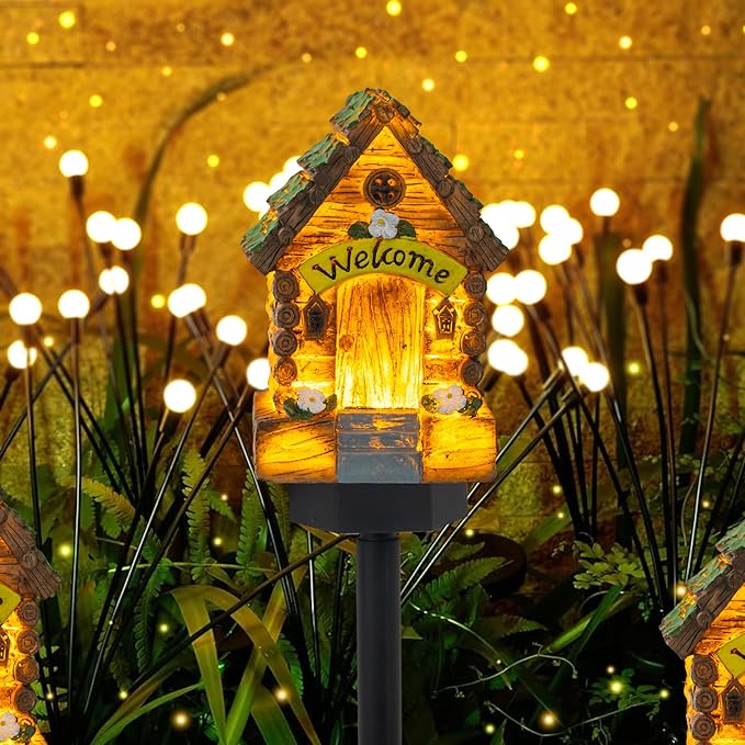 Single glowing miniature wooden fairy house garden light with “Welcome” doorway, on black stake.