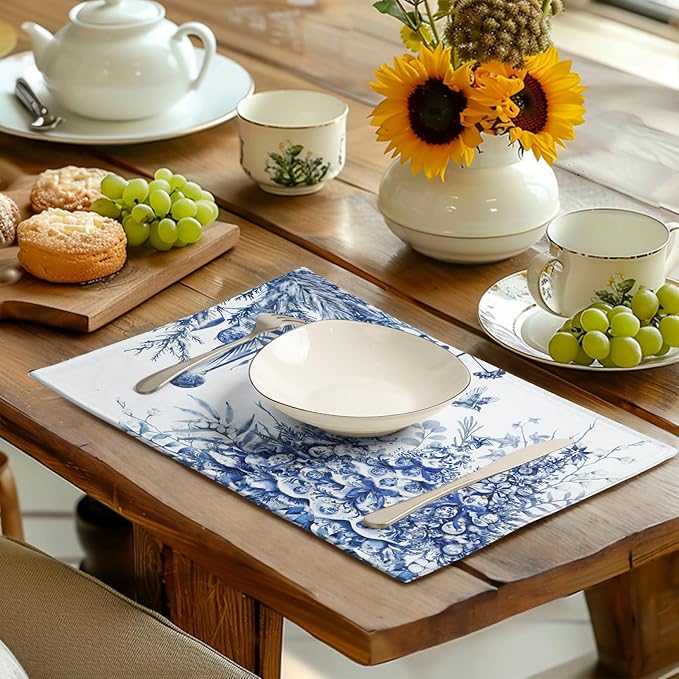 Blue-and-white Christmas tree placemat on a wooden table with dishes