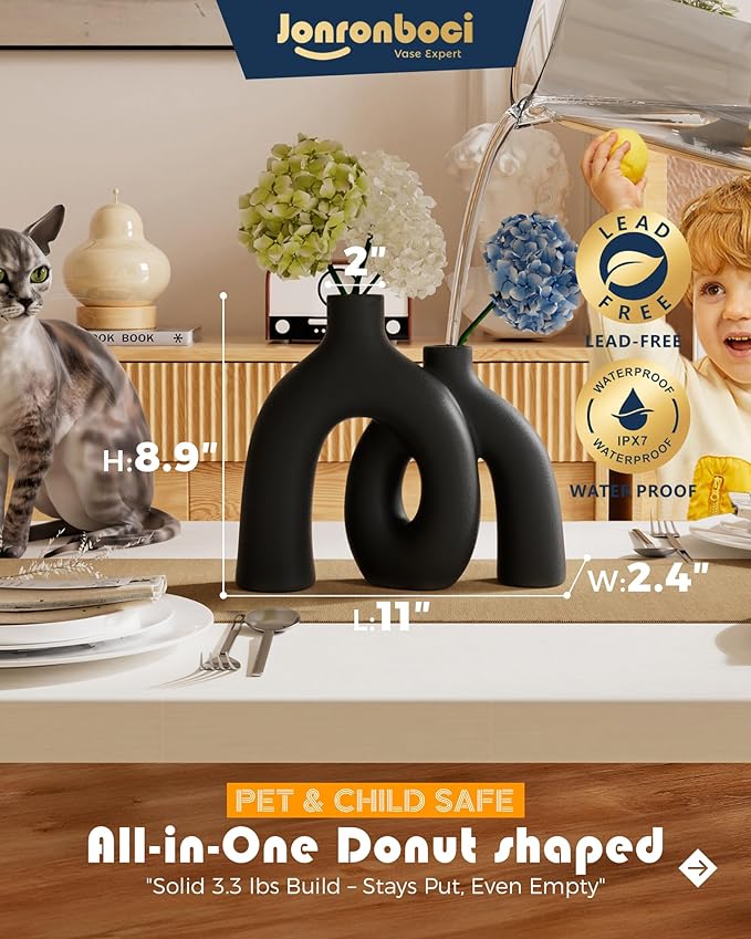 Matte black conjoined ceramic donut vase sculpture with two rounded forms and oval cutout