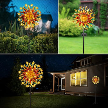 Colorful metal sun wind spinner with LED glow on a garden stake at night