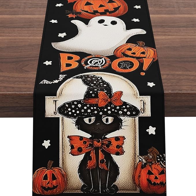 Black Halloween table runner with centered white ghost, pumpkins, bats, and orange BOO design
