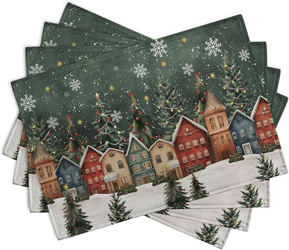 Set of 4 green winter placemats with snowy village scene, fir trees, and star snowflakes