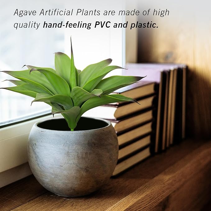 Dark green faux agave plant in a round gray pot