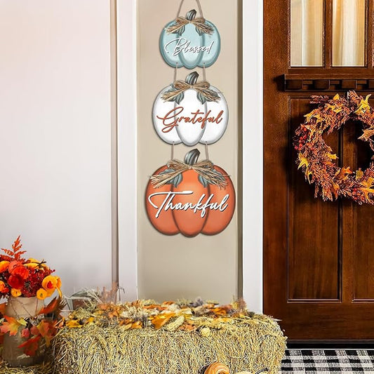 Three hanging fall wall signs shaped like pumpkins: Blessed, Grateful, Thankful.