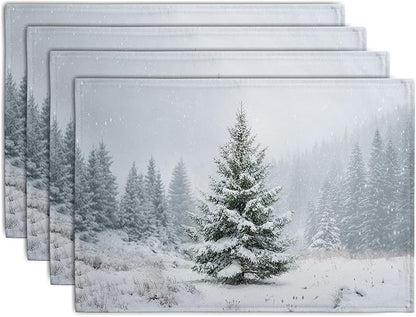 Set of 4 winter placemats with snowy pine tree scene, light gray fabric.