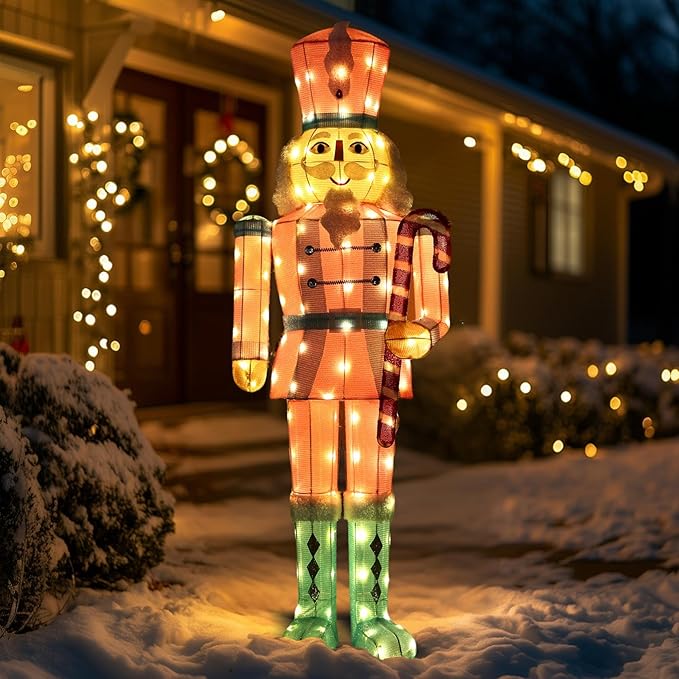LED-lit nutcracker yard stake decor with glowing orange face, red-and-white coat, green boots