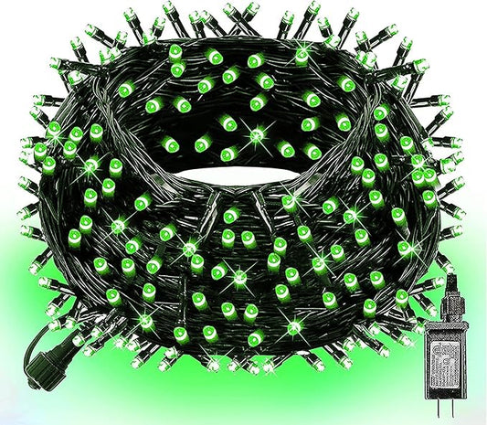 Green LED string lights bundle with glowing bulbs on black wire and plug end
