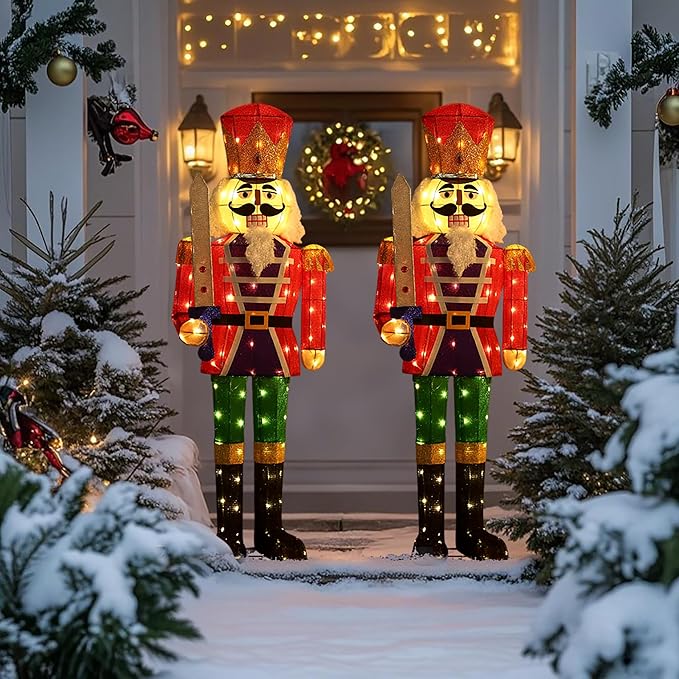 Two standing lighted nutcracker figures with red hats, glittery LED arms, and green pants