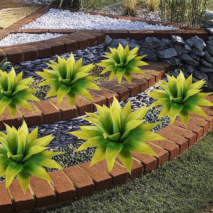 Faux agave plants with yellow-green leaves arranged across outdoor brick steps