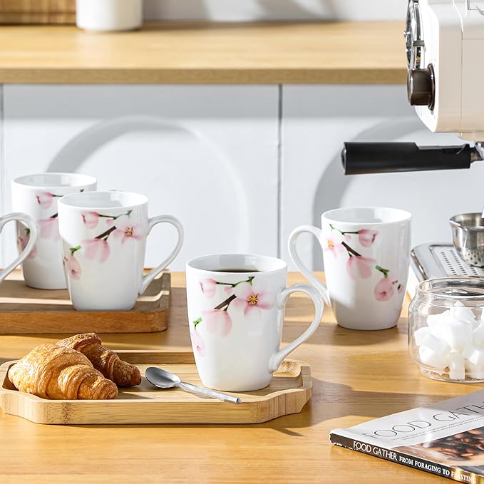 Floral ceramic coffee mug set on table, white cups with pink flower pattern
