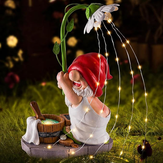 Solar garden gnome statue with red hat, white beard, and warm string lights by barrels