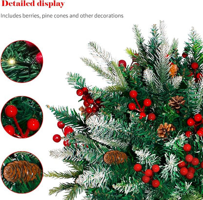 Close-up of pre-lit artificial pine tree branches with red berries, pine cones, and warm LEDs